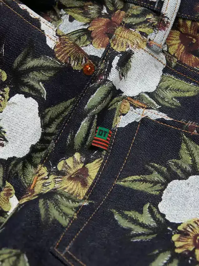 Pantaloni in Denim a zampa larga con motivo floreale e cimosa