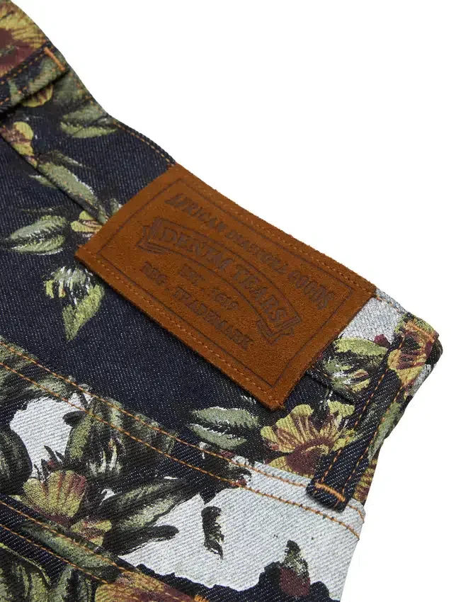 Pantaloni in Denim a zampa larga con motivo floreale e cimosa